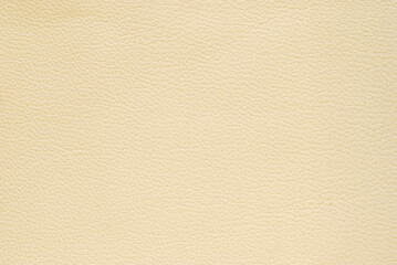 Beige fine pebbled leather texture pattern as background	