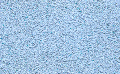 Light blue decorative flakes wall texture or pattern as background