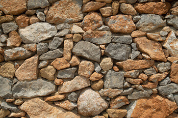 New colorful stone wall closeup in sunny day