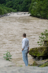 A man looks at the Chorukh River in surprise, Georgia