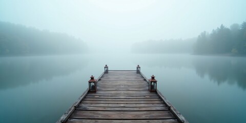 Naklejka premium Wooden Dock Extending Into Misty Lake
