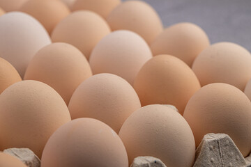 Brown eggs stacked in rows.Group of Fresh white Eggs in a cardboard cassette. Organic food from nature good for health.