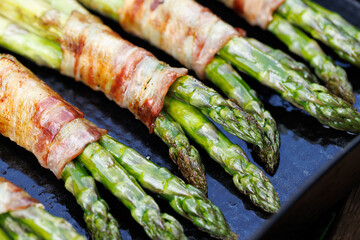 Grilled green asparagus wrapped bacon, close up view