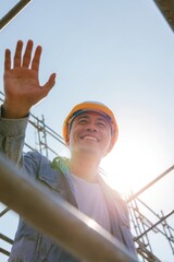 Smiling Asian Construction Worker Waving Scaffold Bright Blue Sky Morning