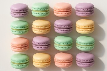 Obraz premium Arrangement of colorful macarons in pastel shades on a white surface