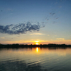 Experience the stunning and breathtaking sunset over a calm and tranquil lake at dusky twilight...