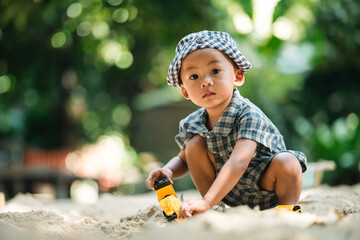 Curious toddler playing with sand outdoors, developing fine motor skills, creativity, and cognitive growth through hands-on exploration in a safe, natural learning environment under sunlight