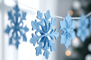 Decorative blue snowflakes hanging on a string, adding a touch of winter magic to the festive season
