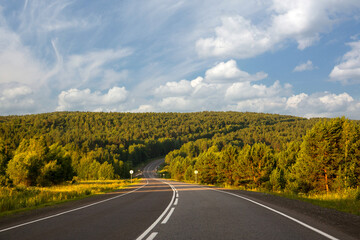 Obraz premium Highway outside the city among the fields and forests