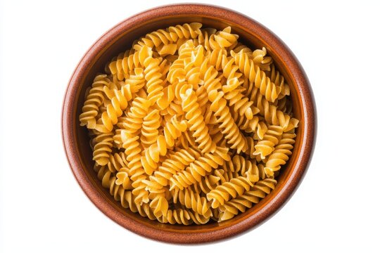 A bowl of uncooked rotini pasta, isolated on white background