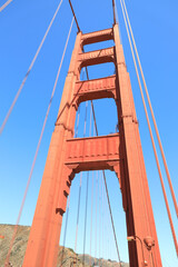 Close up of single tower of Golden Gate Bridge in white clouds San Francisco, USA, bottom view
