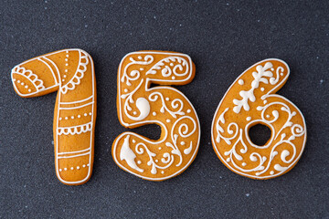 156 number Gingerbread decorated with white sugar glaze. Food background. Christmas cookies.
