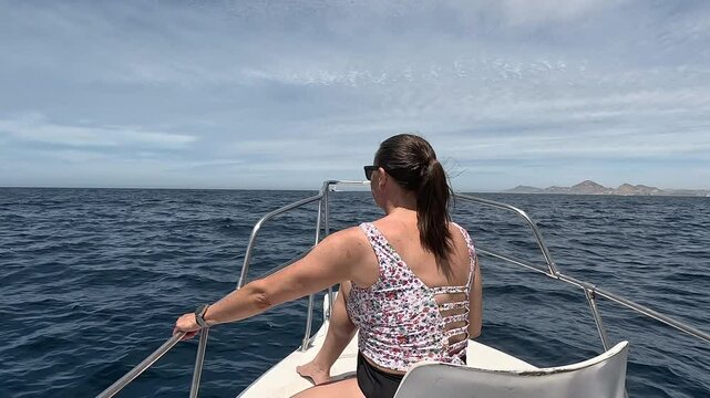 Cabo San Lucas Mexico fishing boat woman bow. Cabo San Lucas Mexico fishing boat woman bow. Cabo, resort city at southern tip of the Baja California peninsula. Eco tourism is source of tourism income.