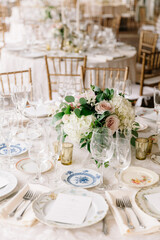 Elegant wedding reception table setting with floral centerpiece and fine dining arrangements in a beautiful venue