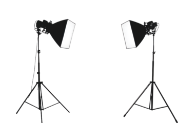 Two black and white lighting stands with a white background