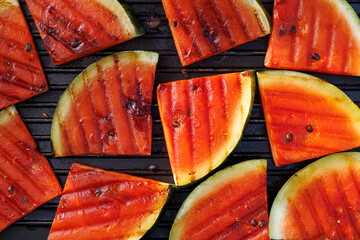 Grilled watermelon slices on a grill plate, close up view, top view