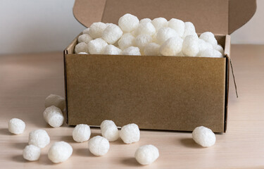 cardboard box filled with biodegradable packing peanuts from corn starch, eco-friendly filler modern shipping practices focused on reducing plastic waste , protecting fragile items during transport