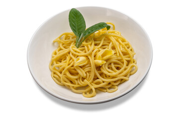 Egg noodles topped with butter and sage in white dish with butter slices and sage leaves, tagliolini in white dish isolated