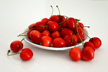 Bold Simplicity – Red Cherries in Bright Light on White Surface
