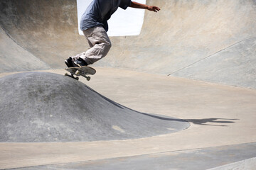 A skateboarder doing a trick on a skate park