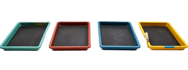 A set of four different colored trays