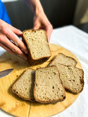 Artisanal gluten free bread held with care. Perfect for small bakery branding, social media, and rustic cooking scenes.
