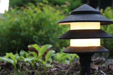 low angle close-up of classic pagoda landscape lighting in a garden. exterior design element