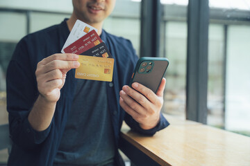 Man Holding Credit Cards and Smartphone