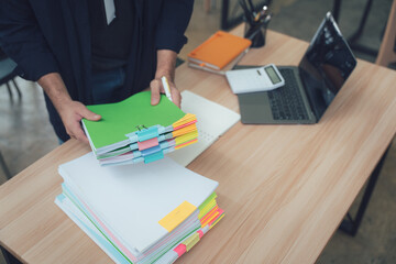 Man Organizing Documents on Office Desk
