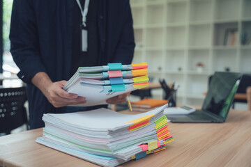 Man Holding Stack of Documents with Colorful Tabs