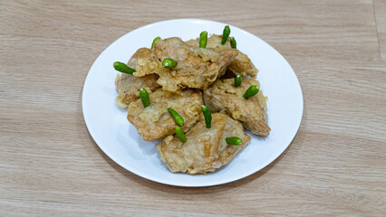 Crispy fried tofu, healthy cooking soybean block tofu in white plate and chilli