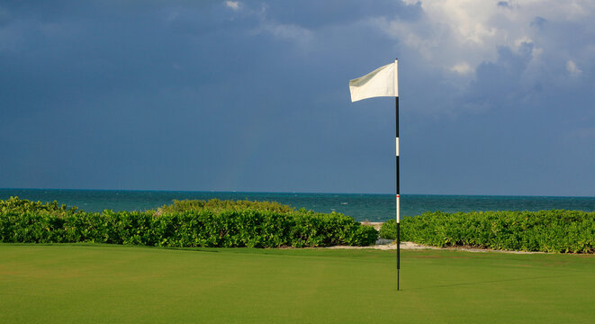 Golf flag and green at tropical Golf Resort.