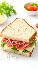 A half sandwich of thinly sliced deli meat and cheese on light bread, garnished with lettuce, served alongside a small bowl of sliced tomatoes and a sprig of parsley.  A scattering of pepper is 