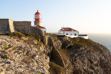 San Vicente Cape lighthouse and cliffs in the Algarve region of Portugal in a sunny day.