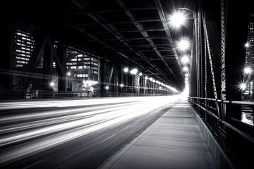 night shot of city bridge scene with street lights, motion blur and long exposure trails and grain, black and white