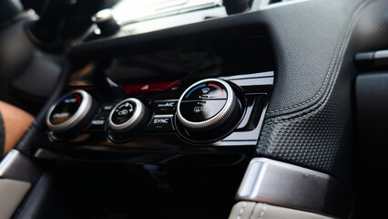 Adjusting temperature controls in a modern car interior