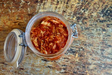 Napa cabbage kimchi in a jar, Korean fermented side dish food.
