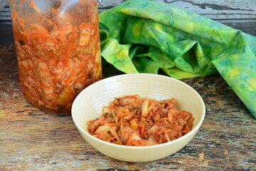 Napa cabbage kimchi in a bowl, Korean fermented side dish food.
