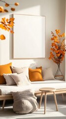 Minimalist autumnal living space featuring a light-colored sofa with beige and mustard yellow cushions, a large blank canvas, and dried orange leaf branches, bathed in natural sunlight.  A light wood
