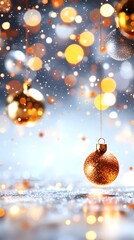 Shimmering gold and copper Christmas ornaments hang against a bokeh backdrop of falling snow and warm lights, creating a festive and magical winter scene