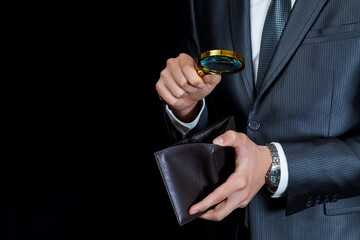 Inspecting a wallet with a magnifying glass