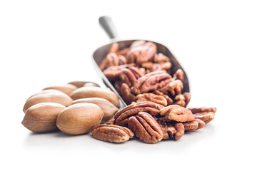 Peeled pecan nuts  in scoop isolated on white background.
