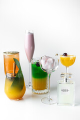 A stylish collection of six colorful cocktails with unique garnishes, displayed on a white background