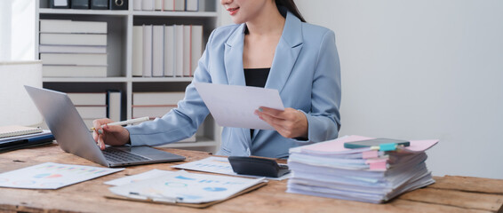 Businesswoman Working with Documents and Laptop