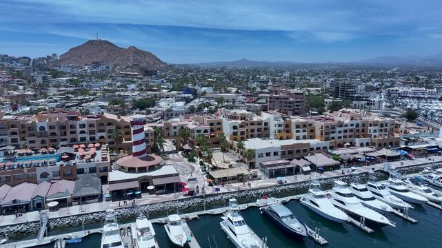 Aerial Cabo San Lucas Mexico marina to city 3. Resort city southern tip of Baja California peninsula. Beach and malecon markets. Eco tourism. Destination vacation and business. Commercial seaport.