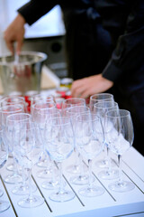 Caterer preparing ingredients and empty wine glasses for a party