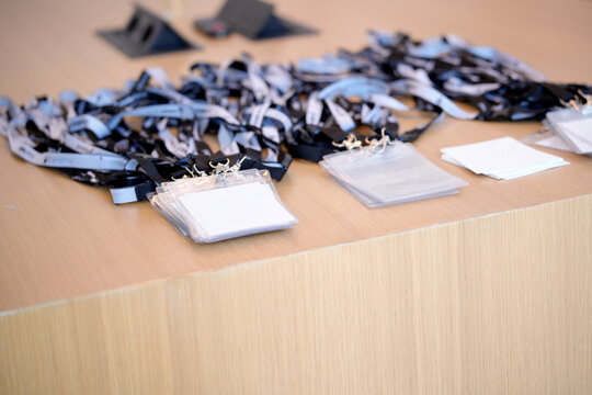 Blank conference badges waiting on registration desk