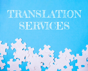 Blue background with white puzzle pieces and the words translation services