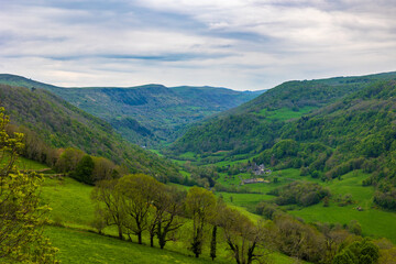 Naklejka premium Landscape of the Maronne Valley under the clouds from Salers