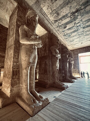 Interior view with giant statues of Ramses II Abu Simbel temple, ancient Egypt